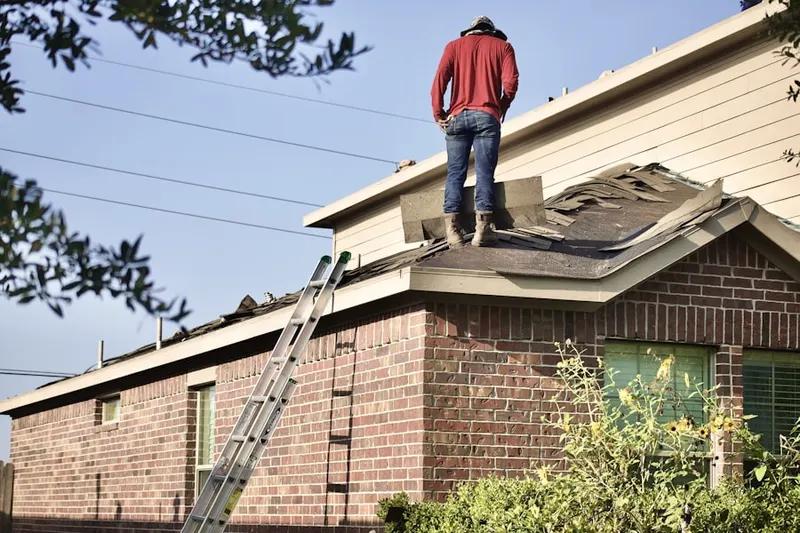Professional roofer working on a residential roof in Fallstaff